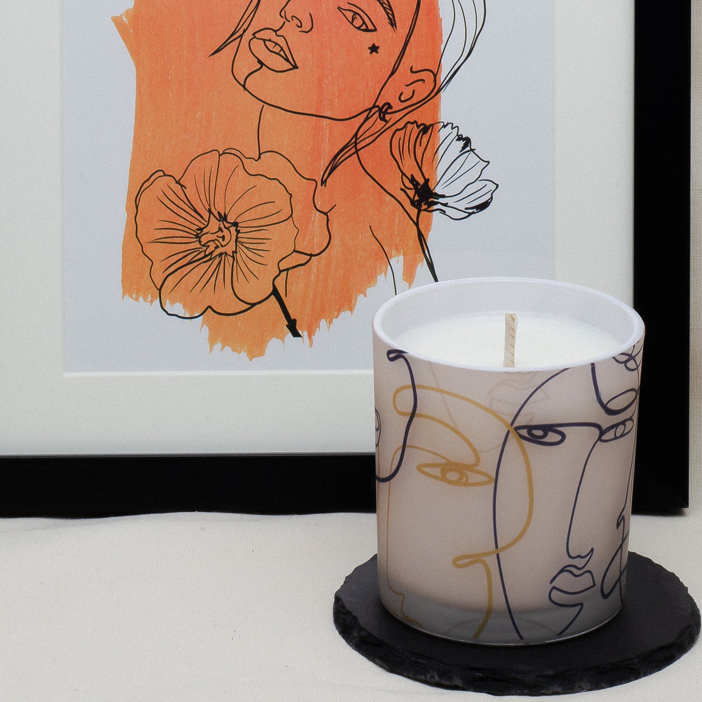 Gult kvinneansikt duftlys i glass